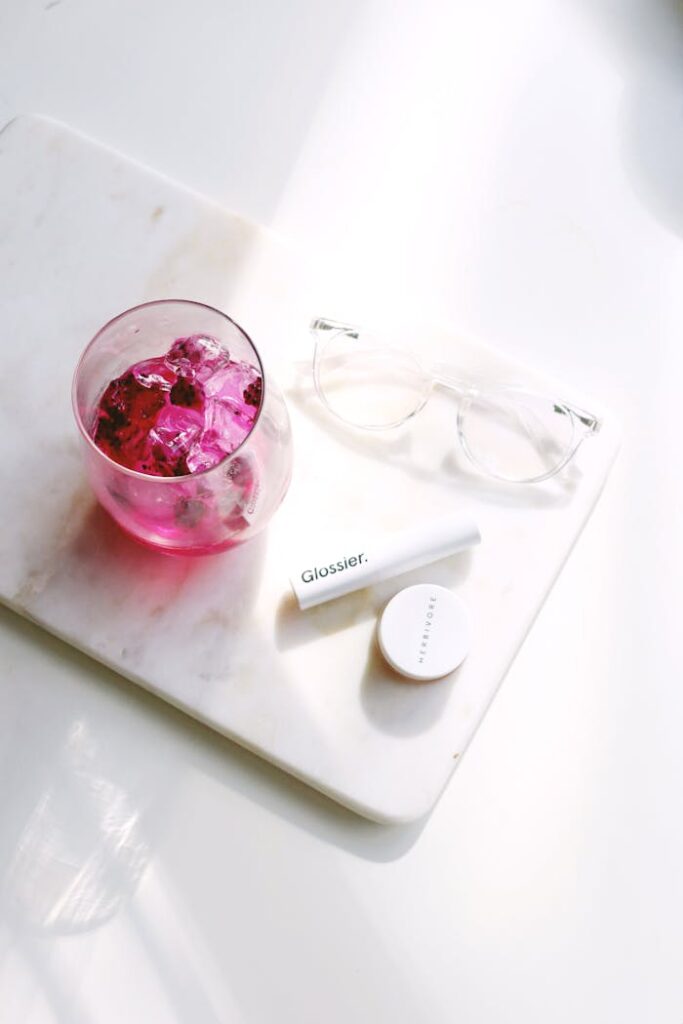 Crafting Captivating Headlines: Your awesome post title goes here Flat lay of cosmetics with pink drink on marble, perfect for beauty and lifestyle themes.